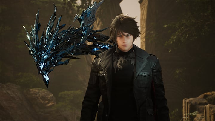 A man in all-black walking through a valley with a strange creature of black energy sprouting from his back.