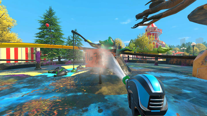 Spraying a sign in a children's theme-park with a powerwasher.