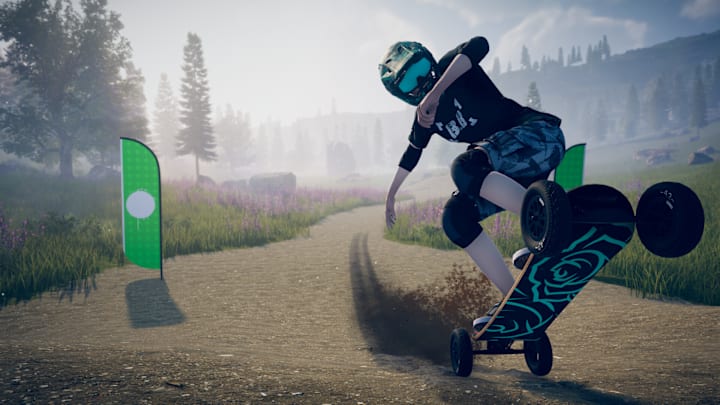 Doing a wheelie down a dirt track on a mountainboard.