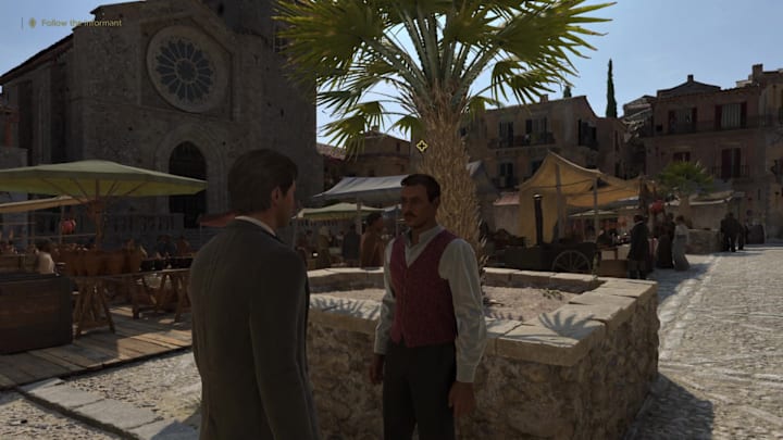 Man in a red waistcoat with objective marker in Mafia: The Old Country.