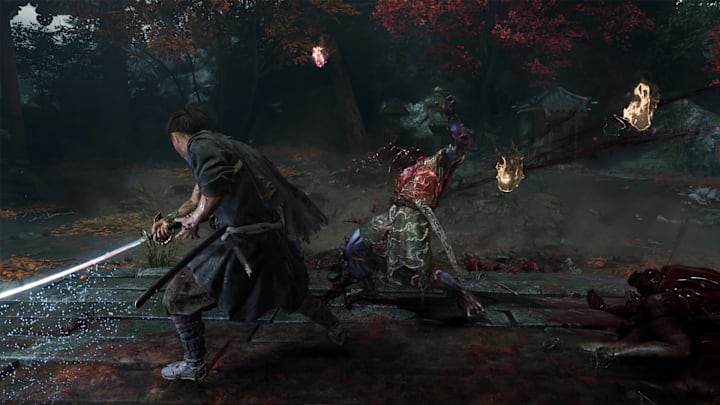 A strange creature being slashed by a samurai, with golden flames coming out.