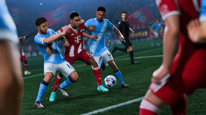 A Bayern Munich player barges through two Manchester City players to get to the ball.