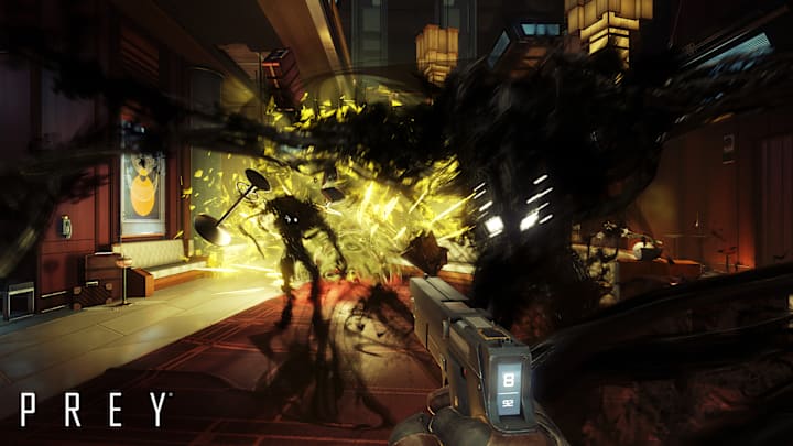 The player shoots an explosive canister as they're attacked by inky aliens in Prey