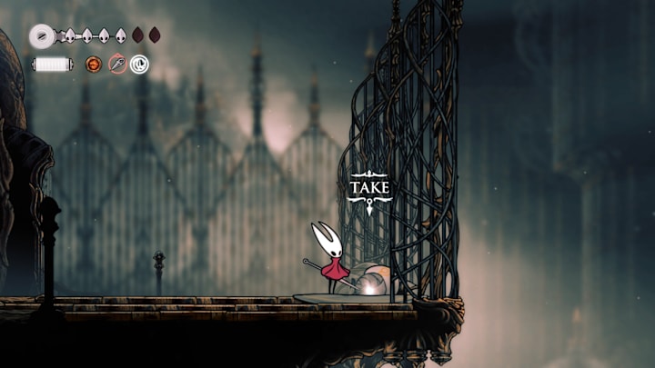 The White Key on the ground next to a large metallic fence.