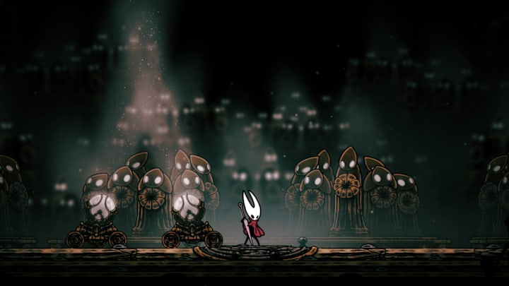 Hornet playing the Needolin as a bunch of statues light up with their eyes.
