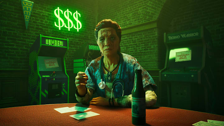 A woman with heavy scars on her face standing in a bar bathed in green light wioth arcade machines behind her.