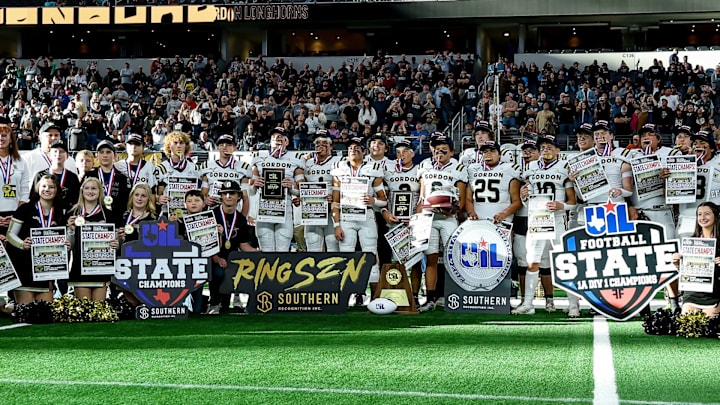 Gordon players poses for a team shot following their victory in the Texas 1A Six-Man Division 1 state title game at AT&T Stadium.