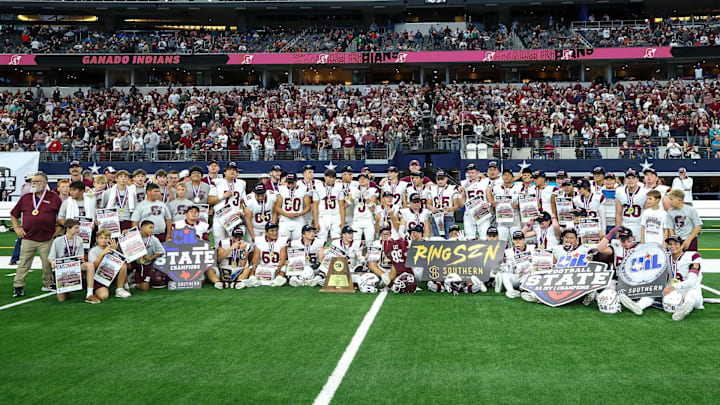 Ganado coaches and players pose for a team champion shot following their victory over Stamford in Texas 2A Division 1 title game at AT&T Stadium.