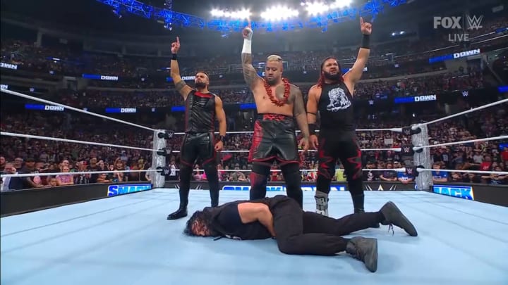 Jacob Fatu, Solo Sikoa, and Tama Tonga of The Bloodline stand tall over Roman Reigns to end WWE Friday Night SmackDown.