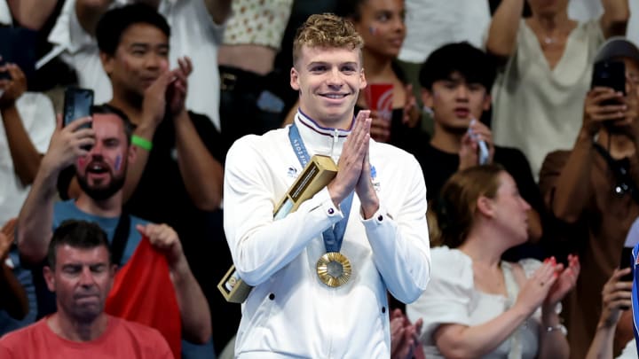 The 22-year-old Marchand won his first gold medal of the Paris Games, to the delight of the French fans.