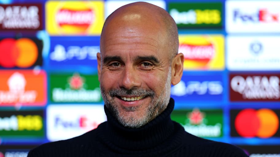 Pep Guardiola grinning.