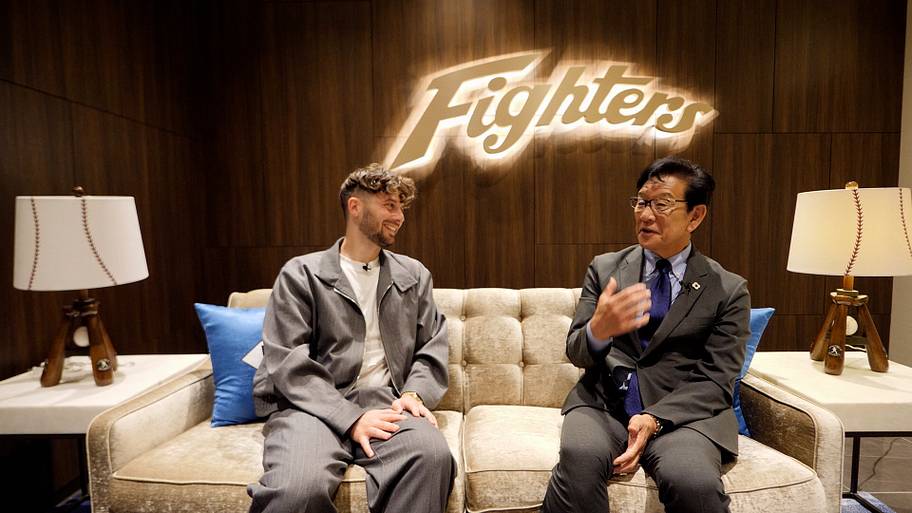 two men sitting on a couch.