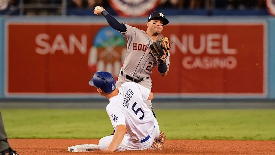 Astros second baseman Jose Altuve tries to turn a double play in 2017 World Series.