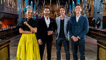 Judges Carla Hall and Jozef Youssef with Hosts James and Oliver Phelps in The Great Hall, as seen on Harry Potter: Wizards of Baking, Season 1.