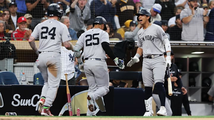 May 25, 2024; San Diego, California, USA; New York Yankees third baseman Oswaldo Cabrera (95), right, cheers after second baseman Gleyber Torres (25) hit a sacrifice fly to score left fielder Alex Verdugo (24) during the fourth inning against the San Diego Padres at Petco Park. Mandatory Credit: Chadd Cady-Imagn Images