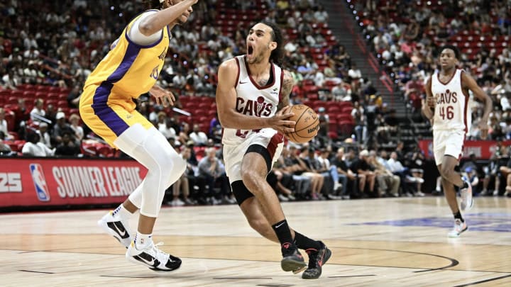 Jaylon Tyson of the Cleveland Cavaliers drives past Moses Brown at the Thomas & Mack Center.