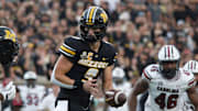 Sept 20, 2025; Columbia, Missouri, USA; Missouri Tigers quarterback Beau Pribula hands off the ball in the first quarter against South Carolina.