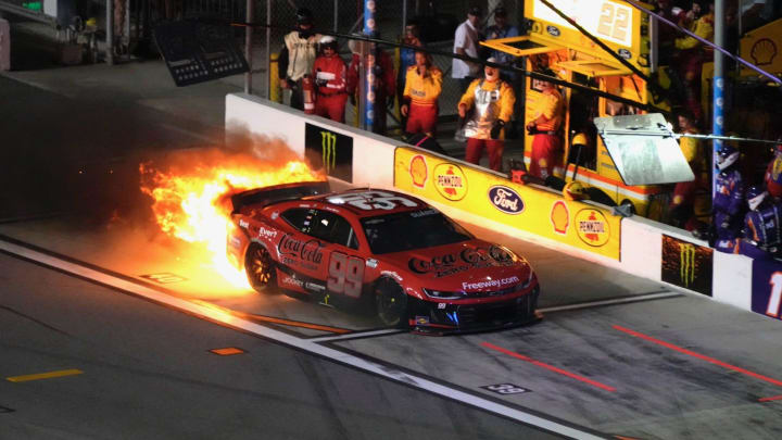 Daniel Suarez's No. 99 Chevrolet catches fire on pit road during the Coke Zero Sugar 400, Saturday, Aug. 24, 2024, at Daytona International Speedway.