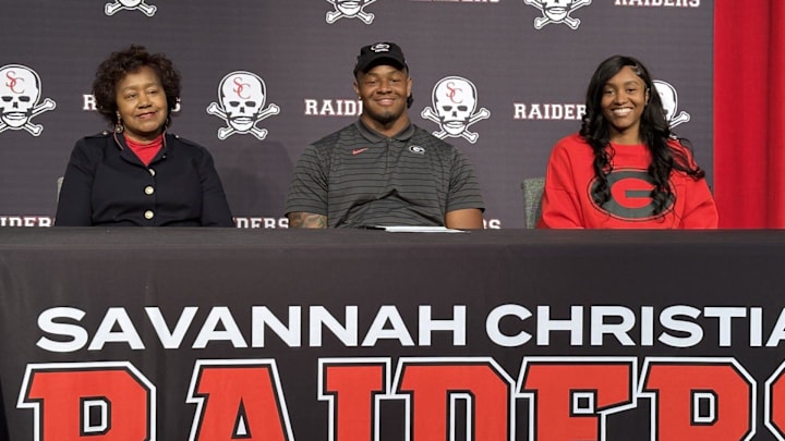 Elijah Griffin, pictured with his mom and grandmother, signed to play football at Georgia on Dec. 4, 2024. Elijah Griffin, pictured with his mom and grandmother, signed to play football at Georgia on Dec. 4, 2024.