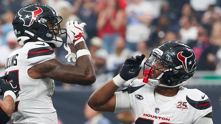   Houston Texans running back David Montgomery (32) reacts to  wide receiver Nico Collins (12)