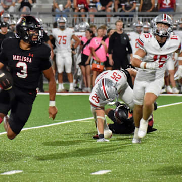 Melissa quarterback Brett Holloway runs toward the end zone in the third quarter of a game Friday against Lucas Lovejoy at Coach Kenny Deel Stadium.