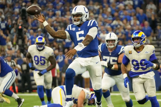 Football player Anthony Richardson makes a pass in a blue jersey.