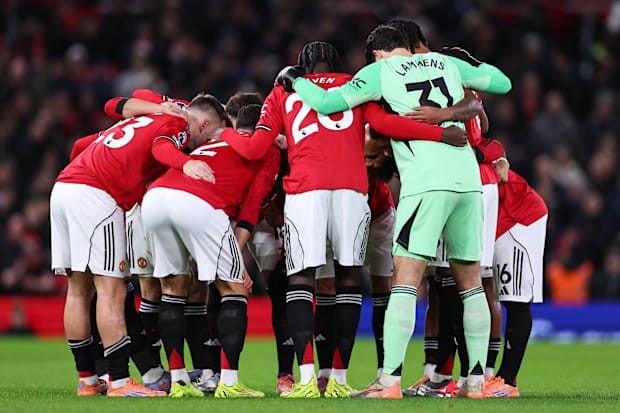 Manchester United players forming a team huddle. Manchester United players forming a team huddle.