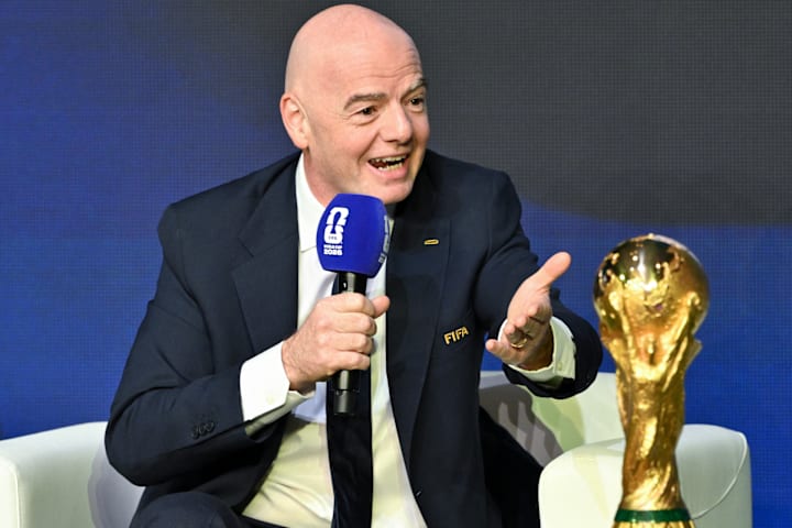 Gianni Infantino next to the World Cup trophy.