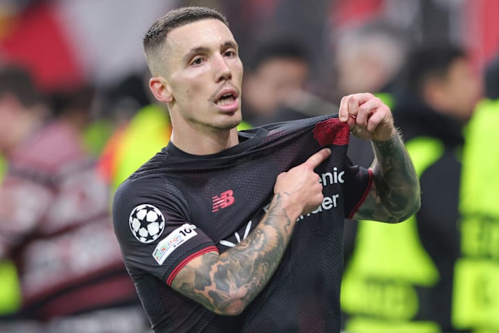 Alejandro Grimaldo pointing to his badge.