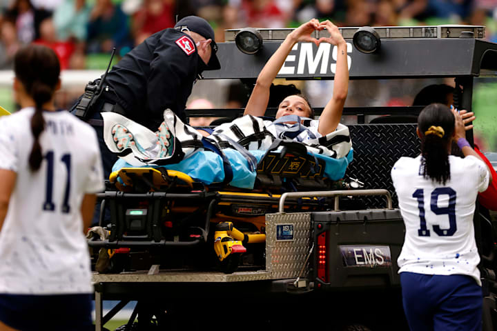 Mallory Swanson #9 of the United States gestures toward fans after being injured against the the Republic of Ireland in a 202