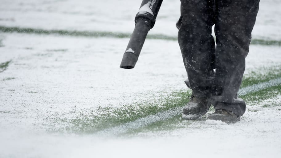 Groundsperson clearing snow.