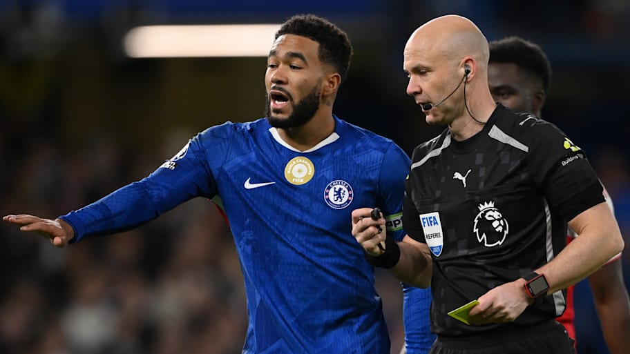 Reece James (left) in discussion with referee Anthony Taylor.