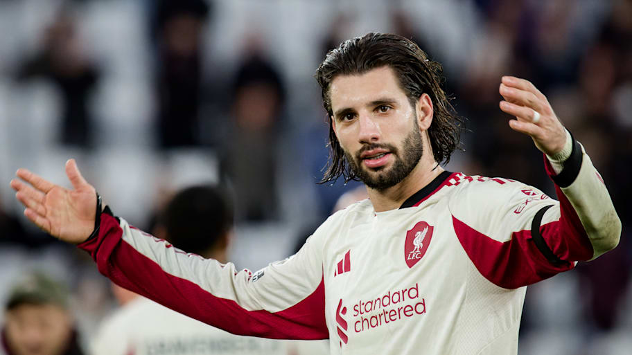 Dominik Szoboszlai with arms raised.