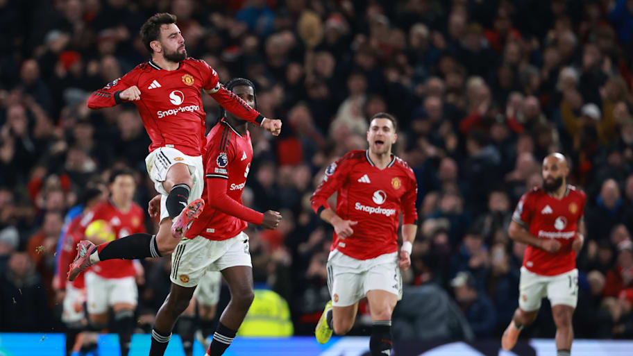 Bruno Fernandes (left) jumping.