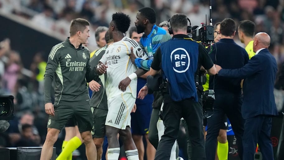 Vinicius Junior getting escorted away.