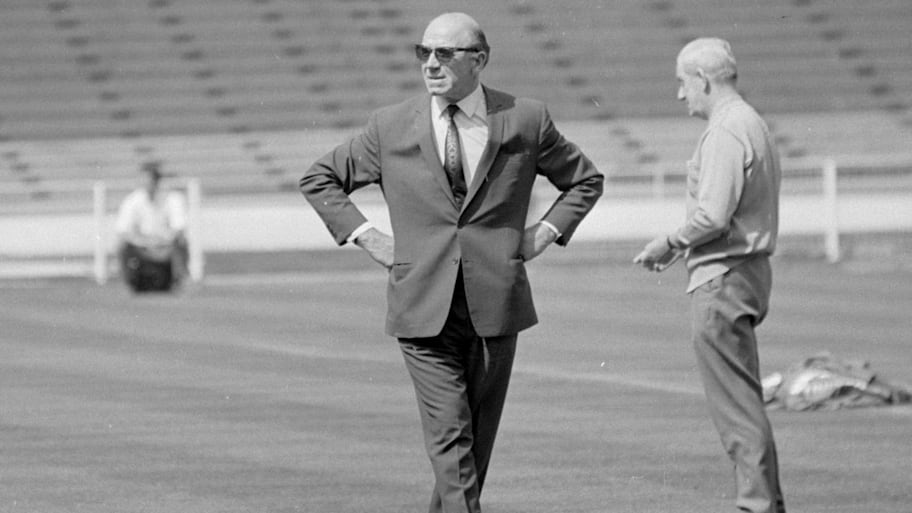 Sir Matt Busby patrolling the pitch.
