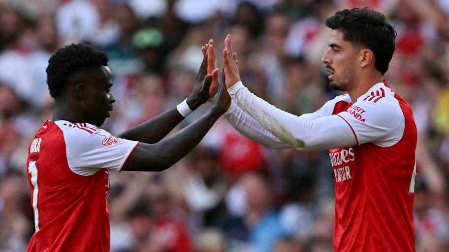Bukayo Saka (left) high-fiving Kai Havertz.