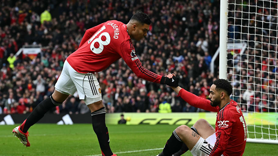 Casemiro (left) helping up Matheus Cunha.