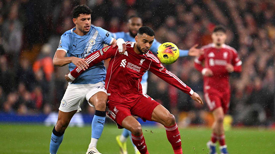 Cody Gakpo (centre) backing into Matheus Nunes.