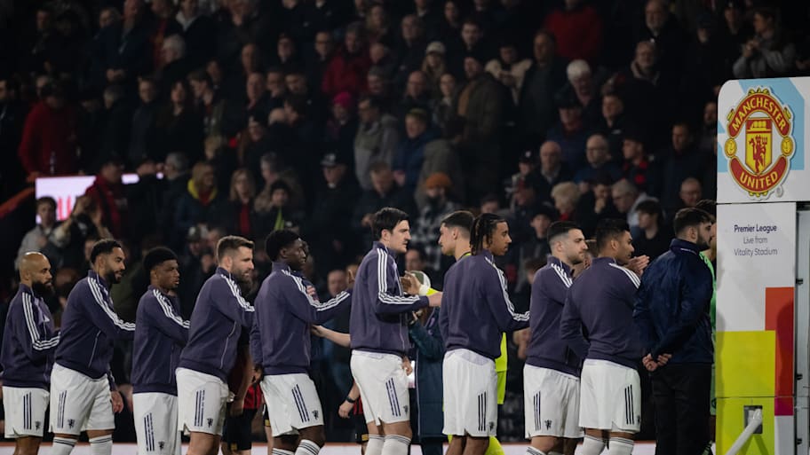 Manchester United players lining up for handshakes.