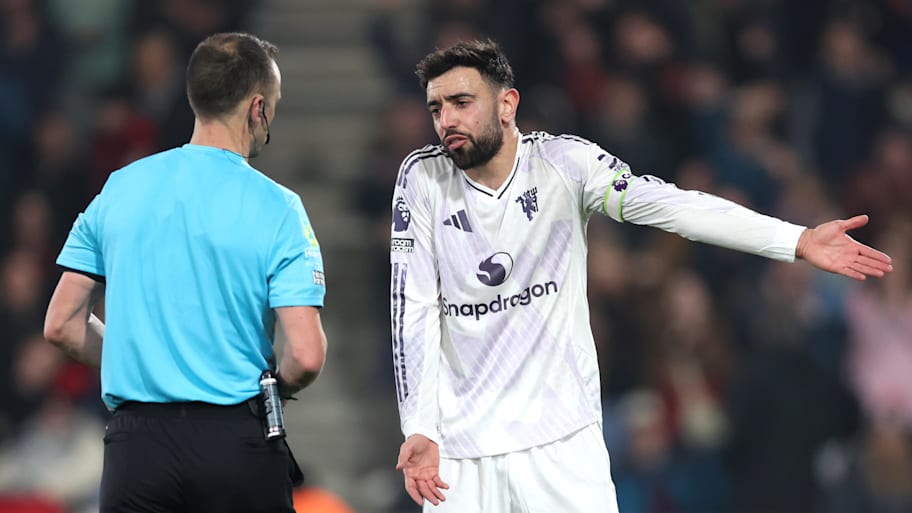 Bruno Fernandes (right) talking to the referee.