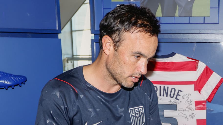 Landon Donovan signing merchandise.