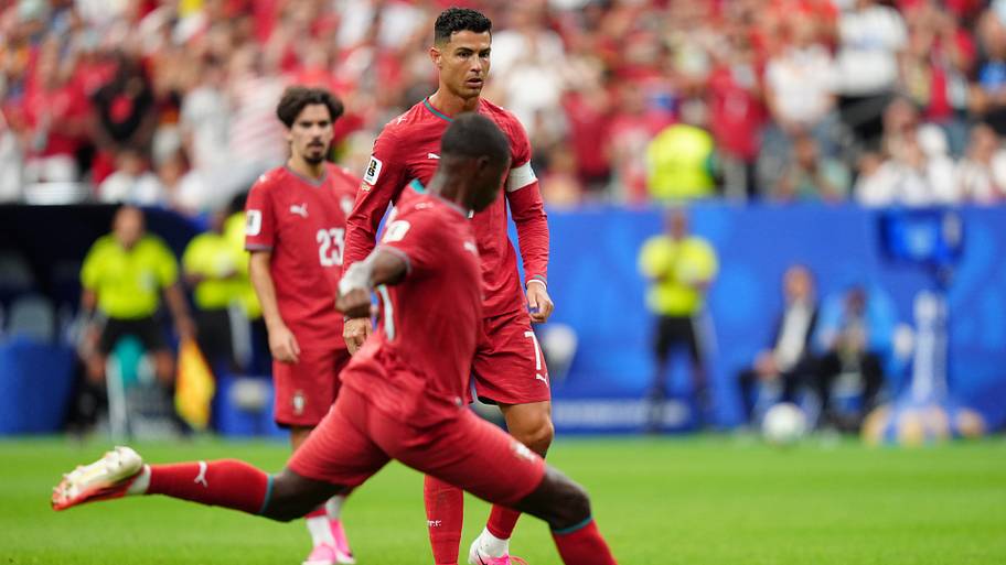 Cristiano Ronaldo (background) letting Nuno Mendes shoot.
