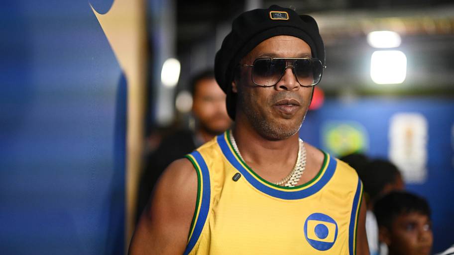 Ronaldinho behind a pair of large sunglasses.