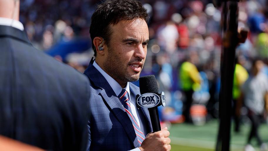 Landon Donovan holding a microphone.