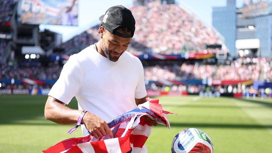 Rome Odunze unfolding a flag.