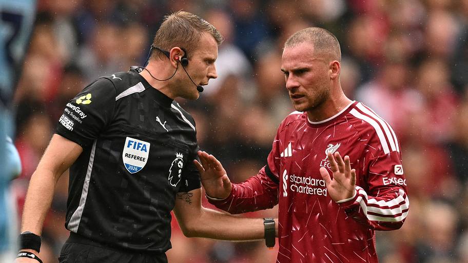 Referee Sam Barrott (left) talking to Alexis Mac Allister.