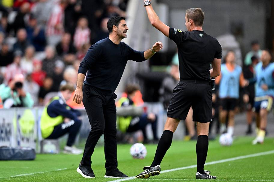 Mikel Arteta (left) getting booked.