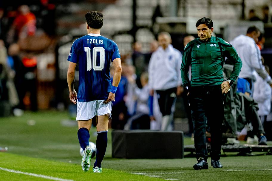 Christos Tzolis rubbing his hamstring.