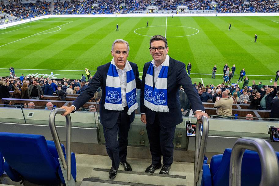 Mark Carney (left) and Andy Burnham at an Everton game.